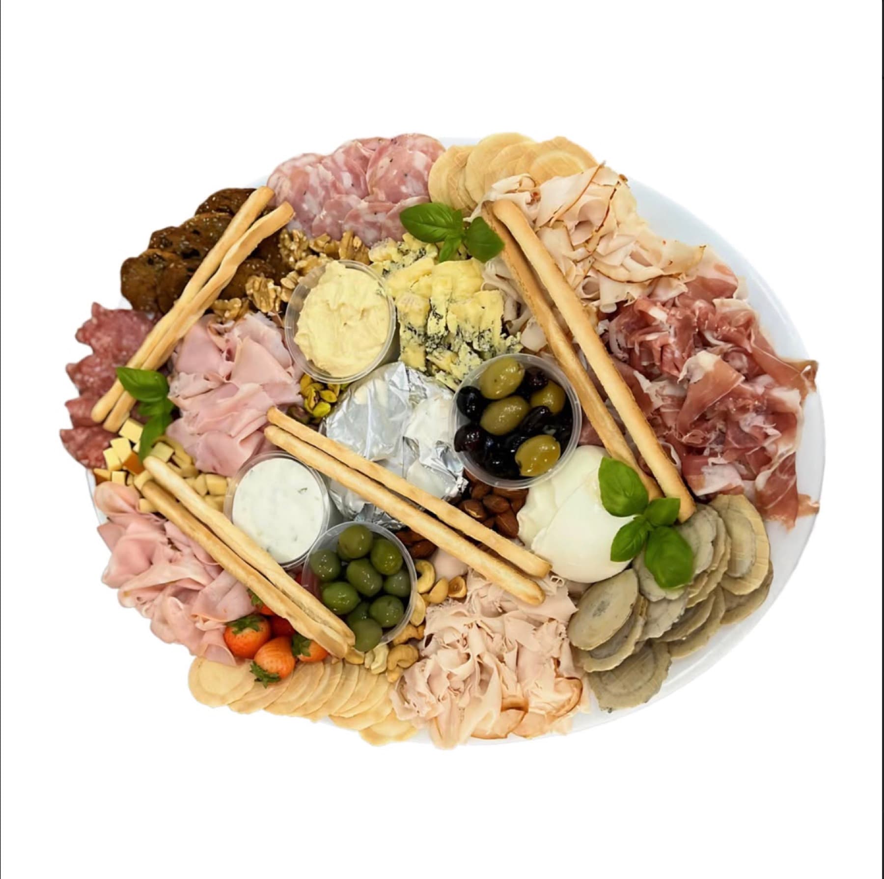 A large charcuterie platter with cured meats, cheeses, olives, grissini and dips