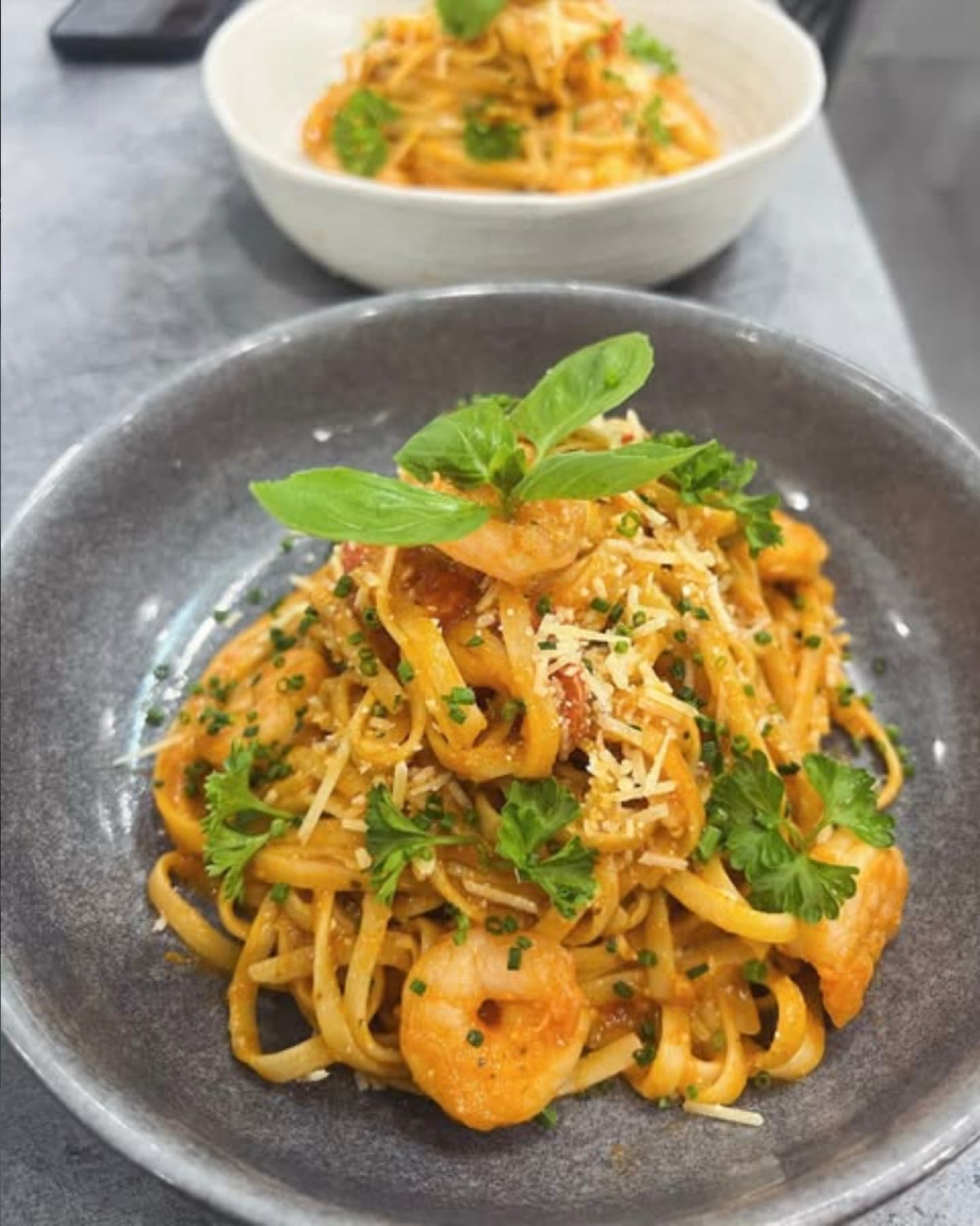 Prawn linguine in a light tomato sauce, finished with parmesan and basil