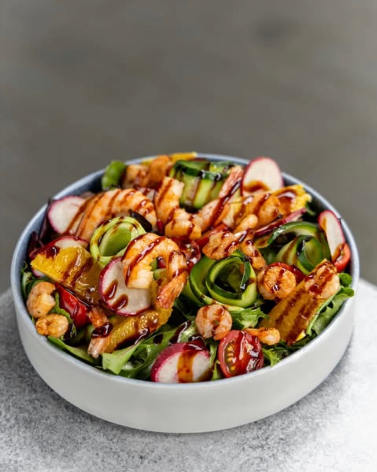 Grilled prawn salad with radish, cucumber ribbons, orange and balsamic glaze